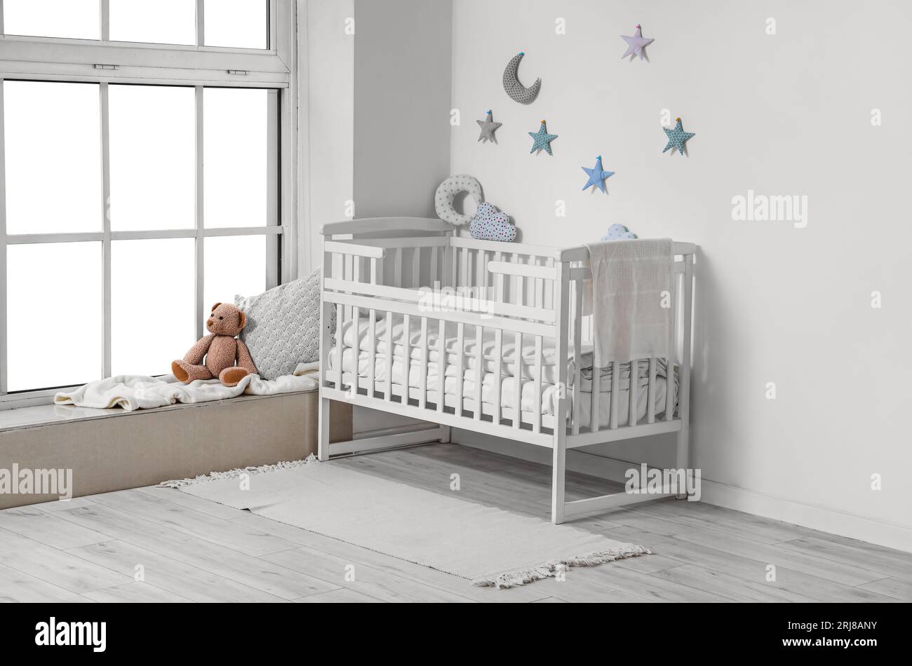 Interior of children's room with crib and teddy bear near window Stock ...
