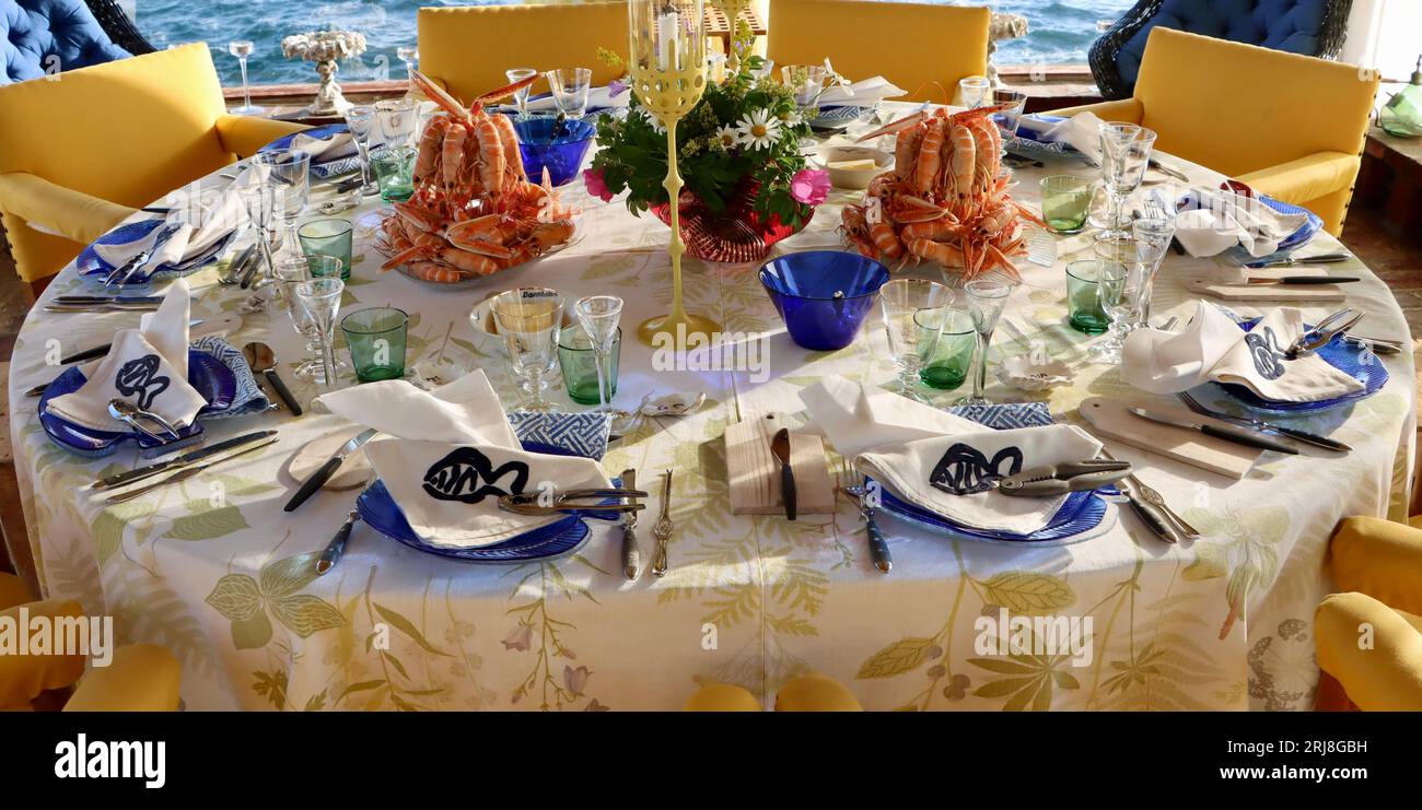Cooked langoustines, Nephrops norvegicus, also called Norway lobsters (havskräfta in Swedish) ready to eat centerpiece on dinner table in Sweden. Stock Photo