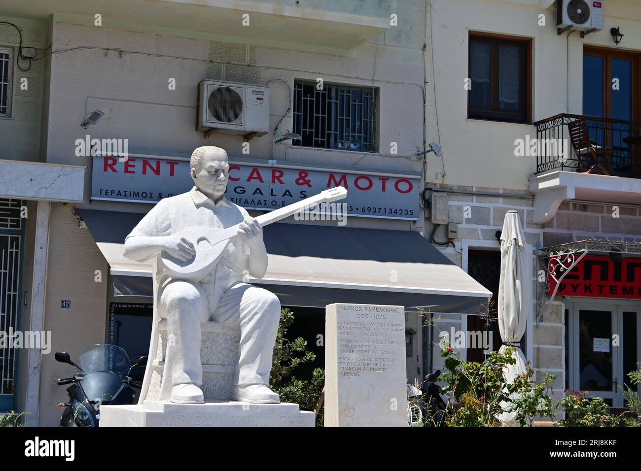Sigalas Rentals and Statue of Bouzouki player, Markos Vamvakaris, Ermoupoli, Syros Island, Greece Stock Photo