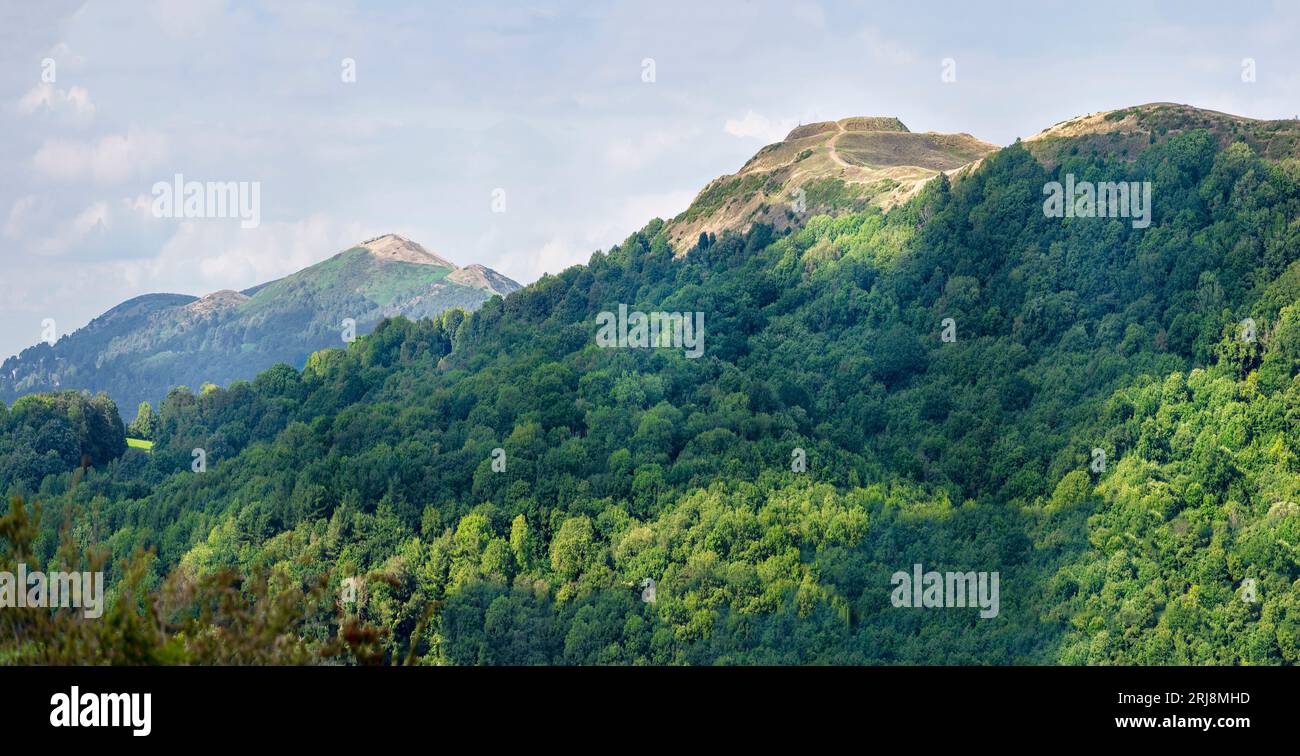 Panoroma of beautiful summer scene,of Malvern hill range,Worcestershire Beacon in the distance,early evening sunlight,shining on to the peaks,famous l Stock Photo