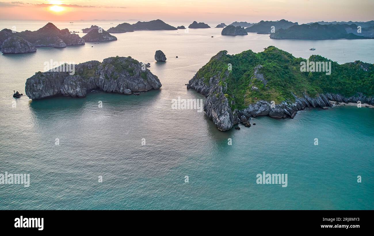 Sunset at Ha long bay - aerial view for limestone islands and rocks in the sea. Stock Photo