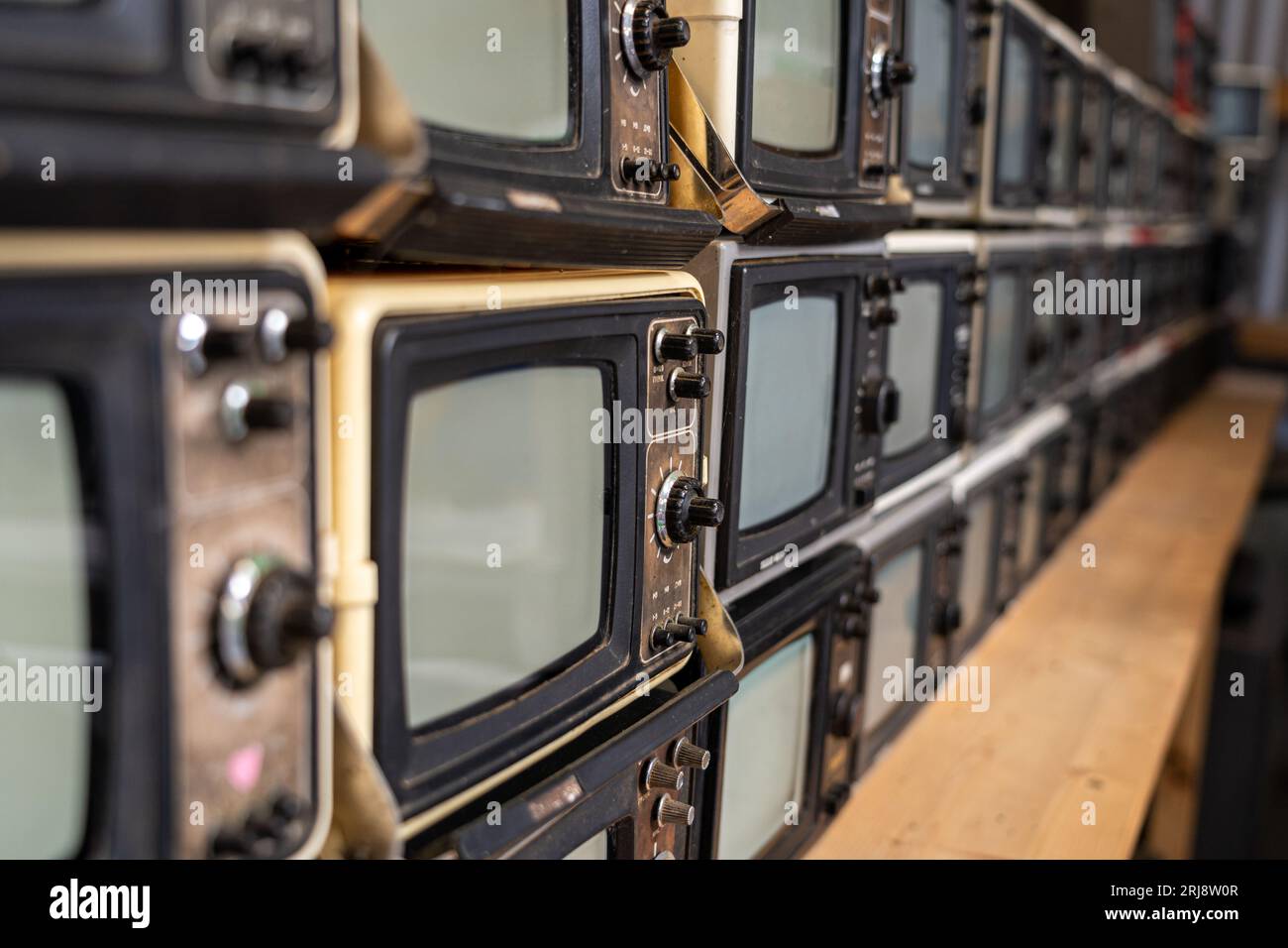 A lot of old small television tv sets stacked Stock Photo