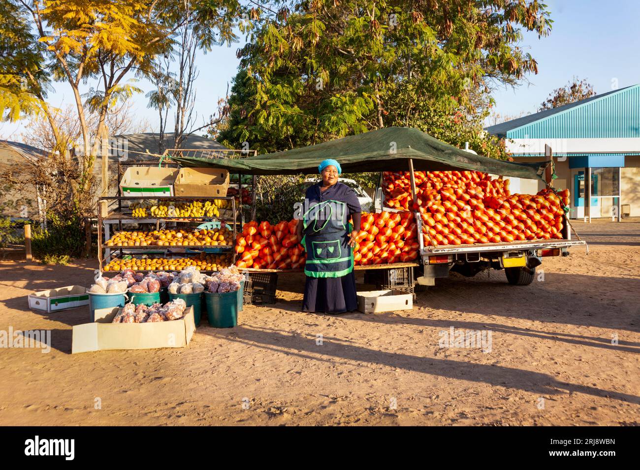 african street vendor in the village on the side of the road, selling fruits, oranges, bananas, peanuts, beans, monkey oranges, from the side of a sma Stock Photo