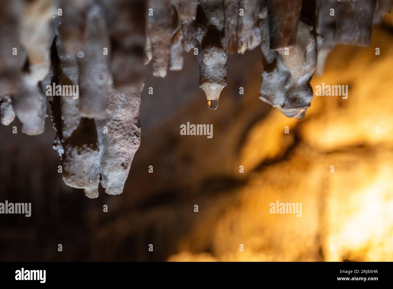 Water drop depositing minerals creating the formations inside of the