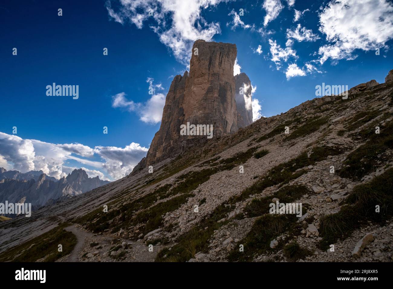 Mountain Peaks of Tre Cime under the blue sky Stock Photo