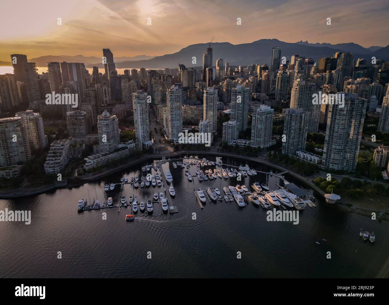 An aerial view of a bustling cityscape of Vancouver Downtown at sunset ...