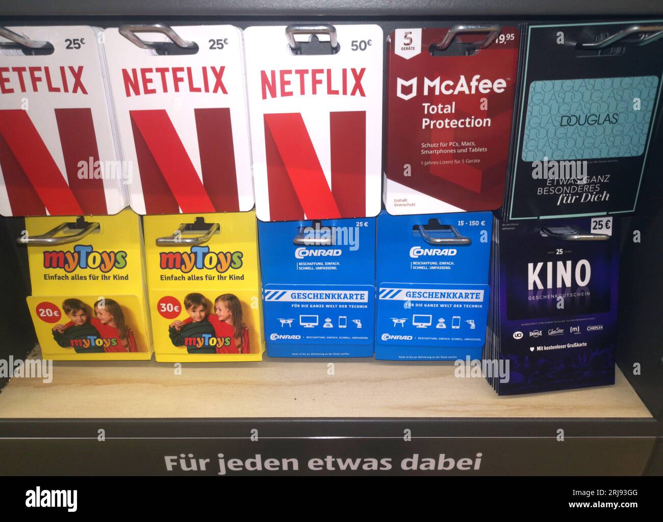WETZLAR, HESSE, GERMANY 03-14-2022: Netflix, McAfee, Douglas, myToys, and Conrad gift cards for sale on a display rack ready for purchase Stock Photo