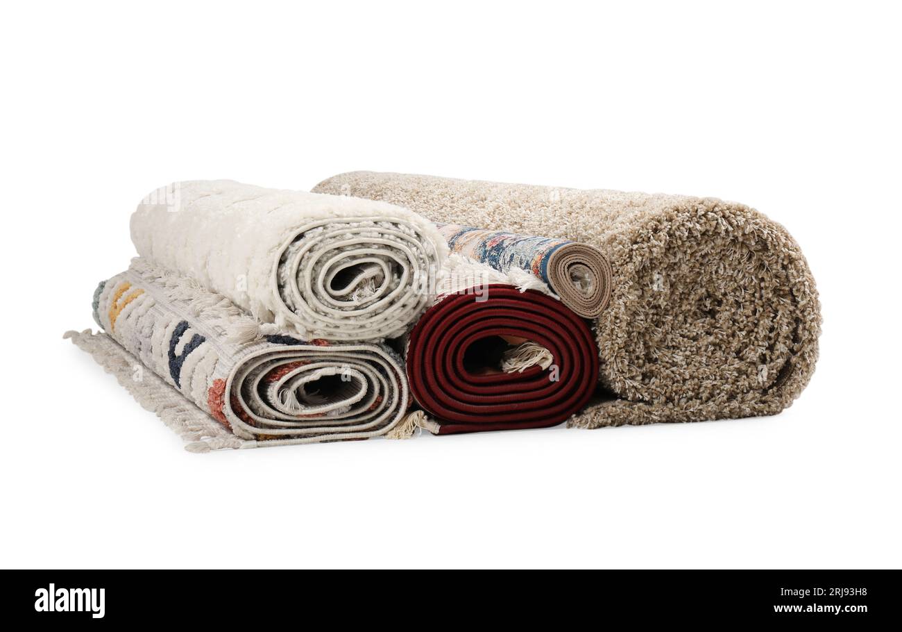 Rolled carpets on white background. Interior element Stock Photo - Alamy