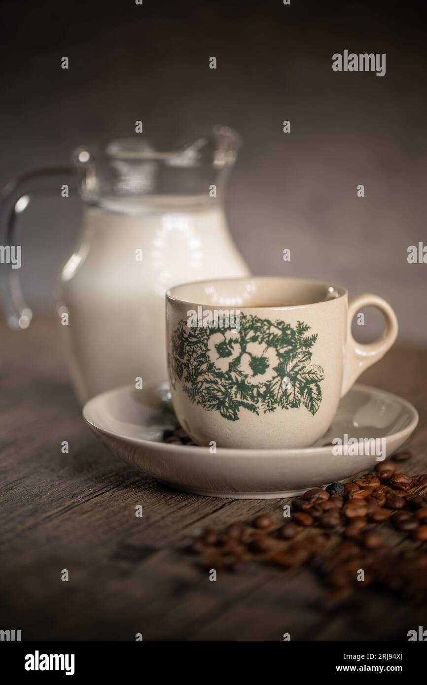 Traditional Floral Porcelain Kopitiam Coffee Cup With a Small Jar of Milk. Malaysian Coffee. Chinese Coffee. Stock Photo