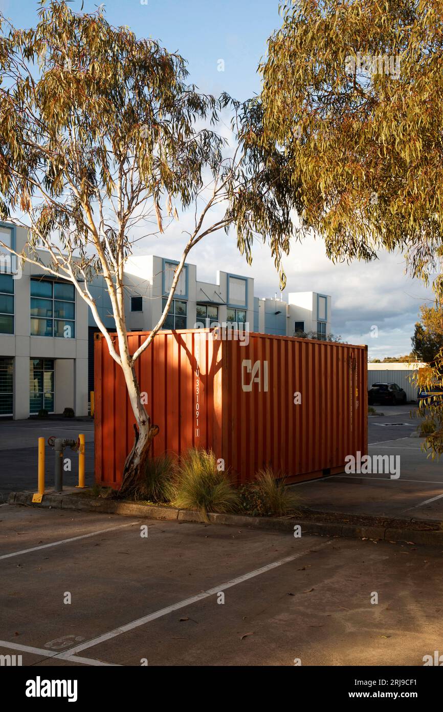 Shipping containers placed in industrial parking spaces, offering