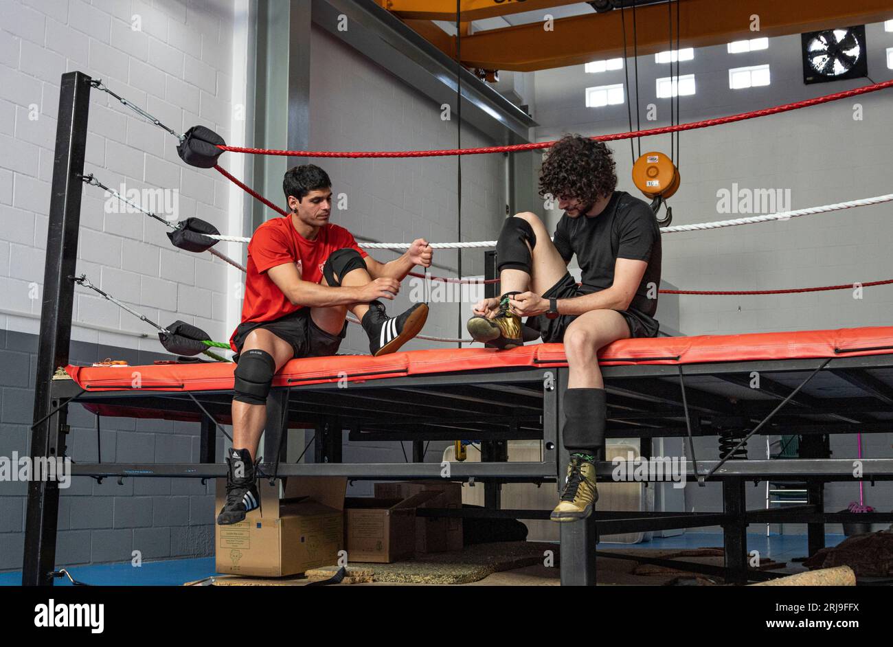 Two young Spanish male wrestlers in traditional wrestling attire are