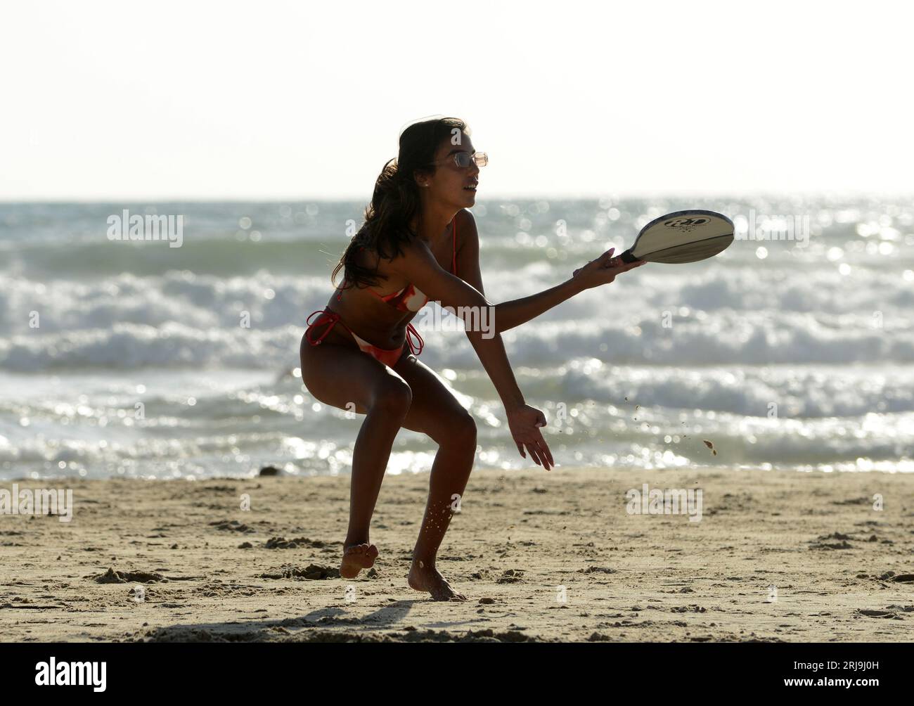 Playing Matkot ( paddle ball ) on the beach in Tel-Aviv. Stock Photo
