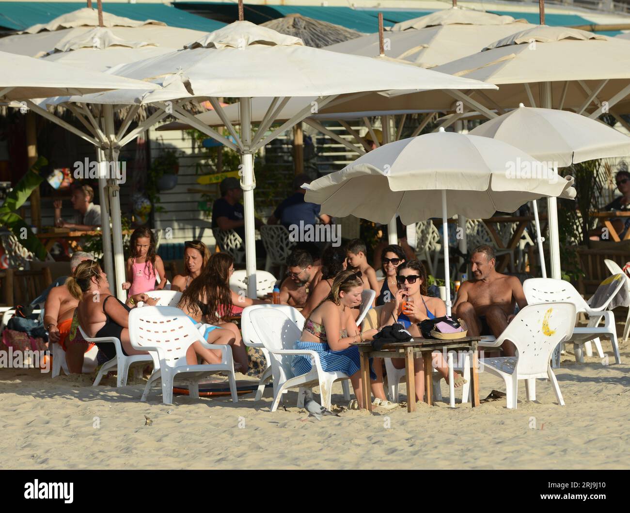 Enjoying drinks at the Banana beach restaurant in Tel-Aviv, Israel. Stock Photo