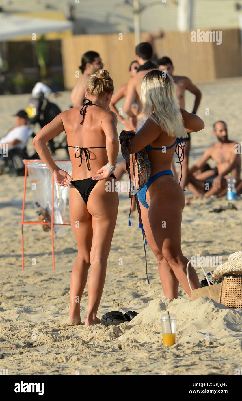 Women in bikini socializing on the beach in Tel-Aviv, Israel. Stock Photo
