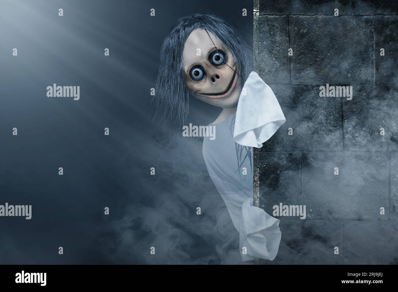 Scary Momo standing behind the wall in the dark background. Scary face for  Halloween. Halloween concept Stock Photo - Alamy