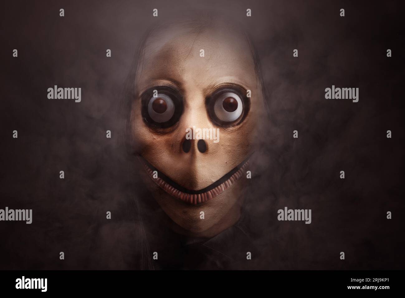 Scary Momo standing behind the wall in the dark background. Scary face for  Halloween. Halloween concept Stock Photo - Alamy