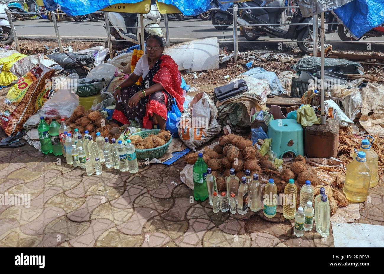Margao, South Goa, India. 22nd Aug, 2023. Cocunut Oil for sale in the Narrow passage ways selling anything imaginable in the busy and colourful market at the city of Margao, South India.Paul Quezada-Neiman/Alamy Live News Credit: Paul Quezada-Neiman/Alamy Live News Stock Photo