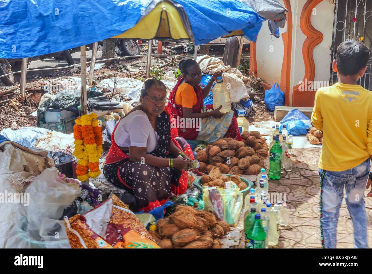 Margao, South Goa, India. 22nd Aug, 2023. Cocunuts for sale in the Narrow passage ways selling anything imaginable in the busy and colourful market at the city of Margao, South India.Paul Quezada-Neiman/Alamy Live News Credit: Paul Quezada-Neiman/Alamy Live News Stock Photo