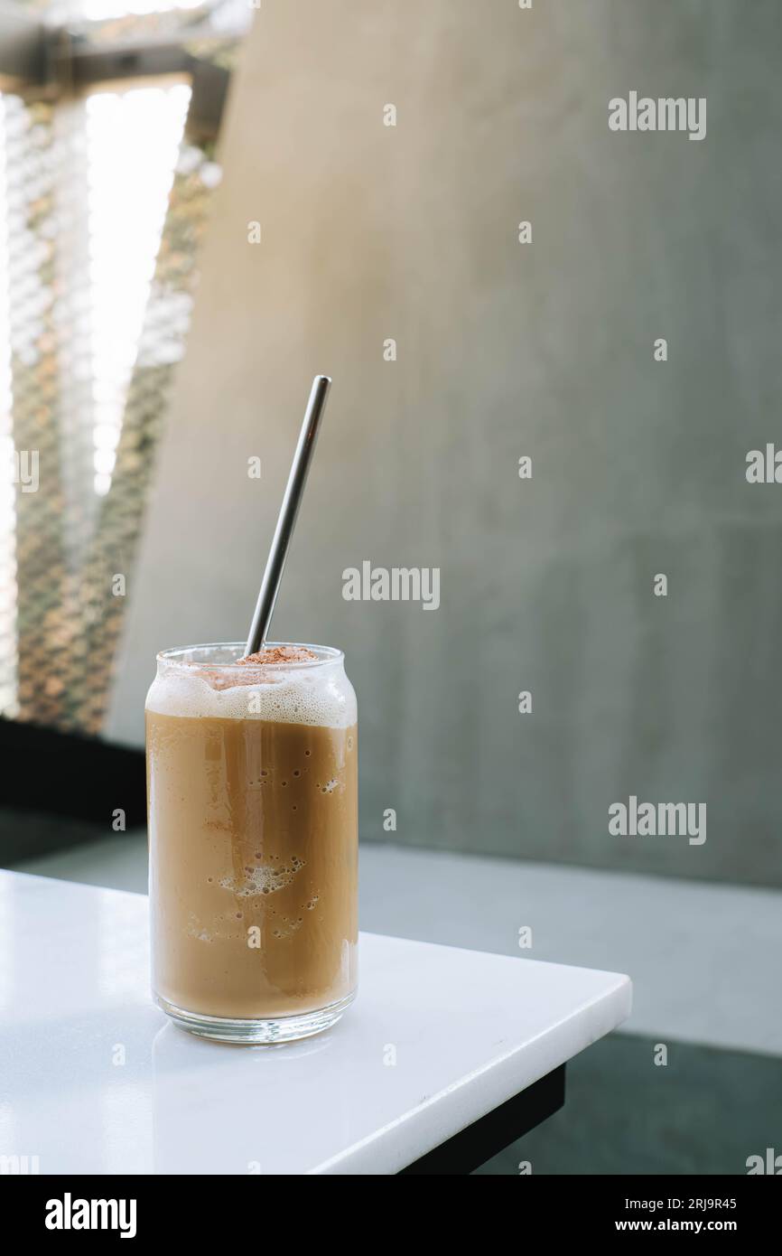 Selective focus shot of a glass of Ice Blended Coffee with stainless steel straw on it Stock Photo