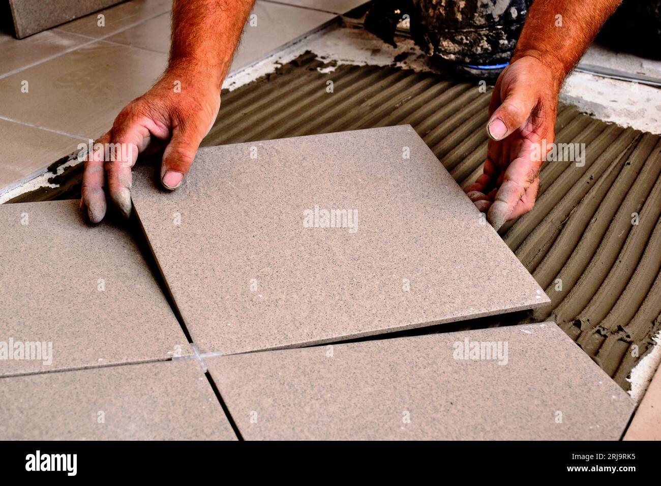 trowel on cement based grout tile base. large ceramic floor tiles