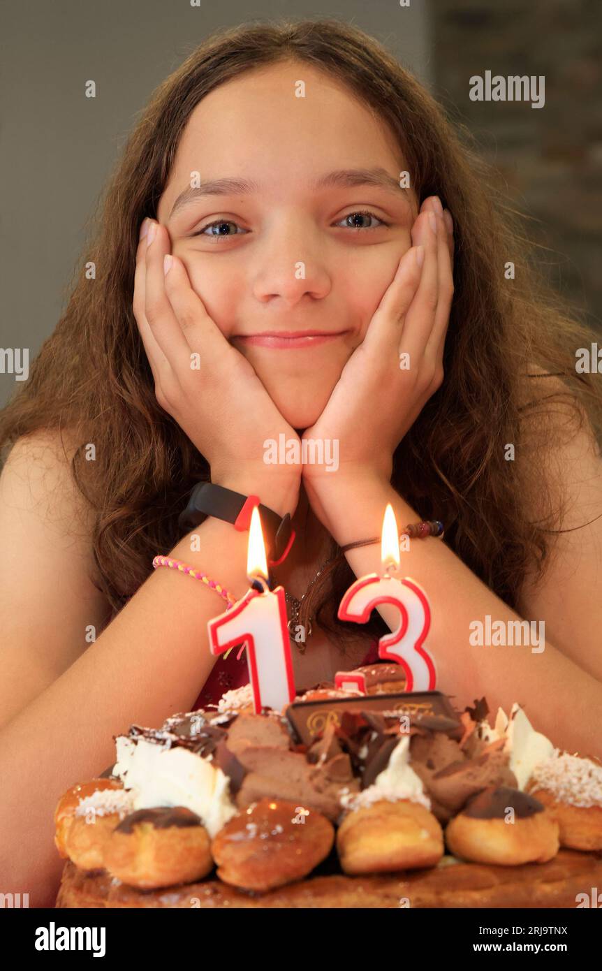 Teenager girl portrait anniversary including birthday cake and candles Stock Photo