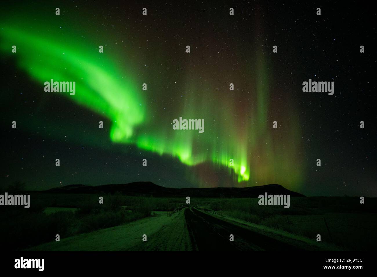 A stunning aurora borealis illuminating the night sky above the rural ...