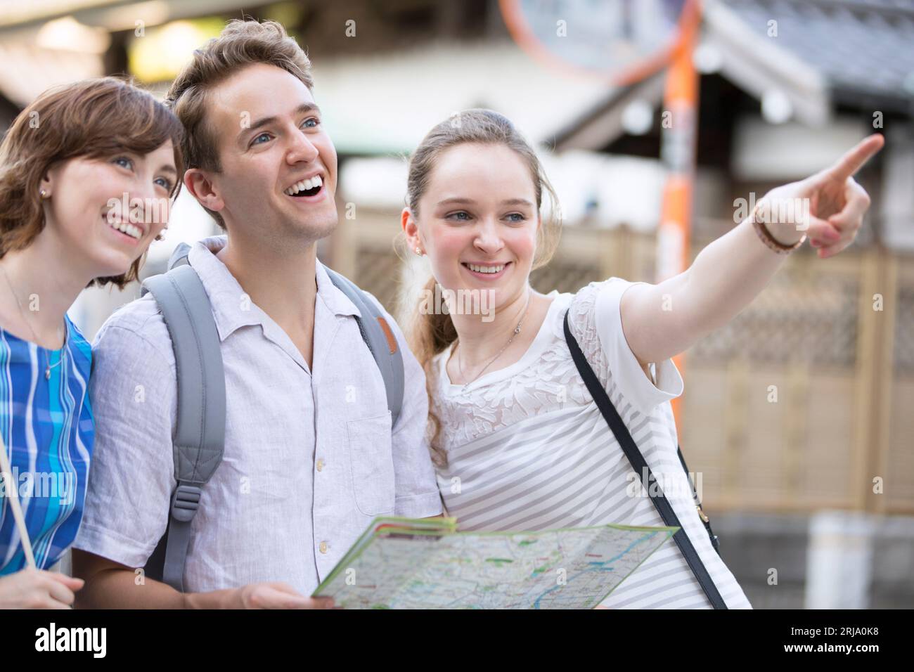 Male and female foreign tourists checking where they are going on a map Stock Photo
