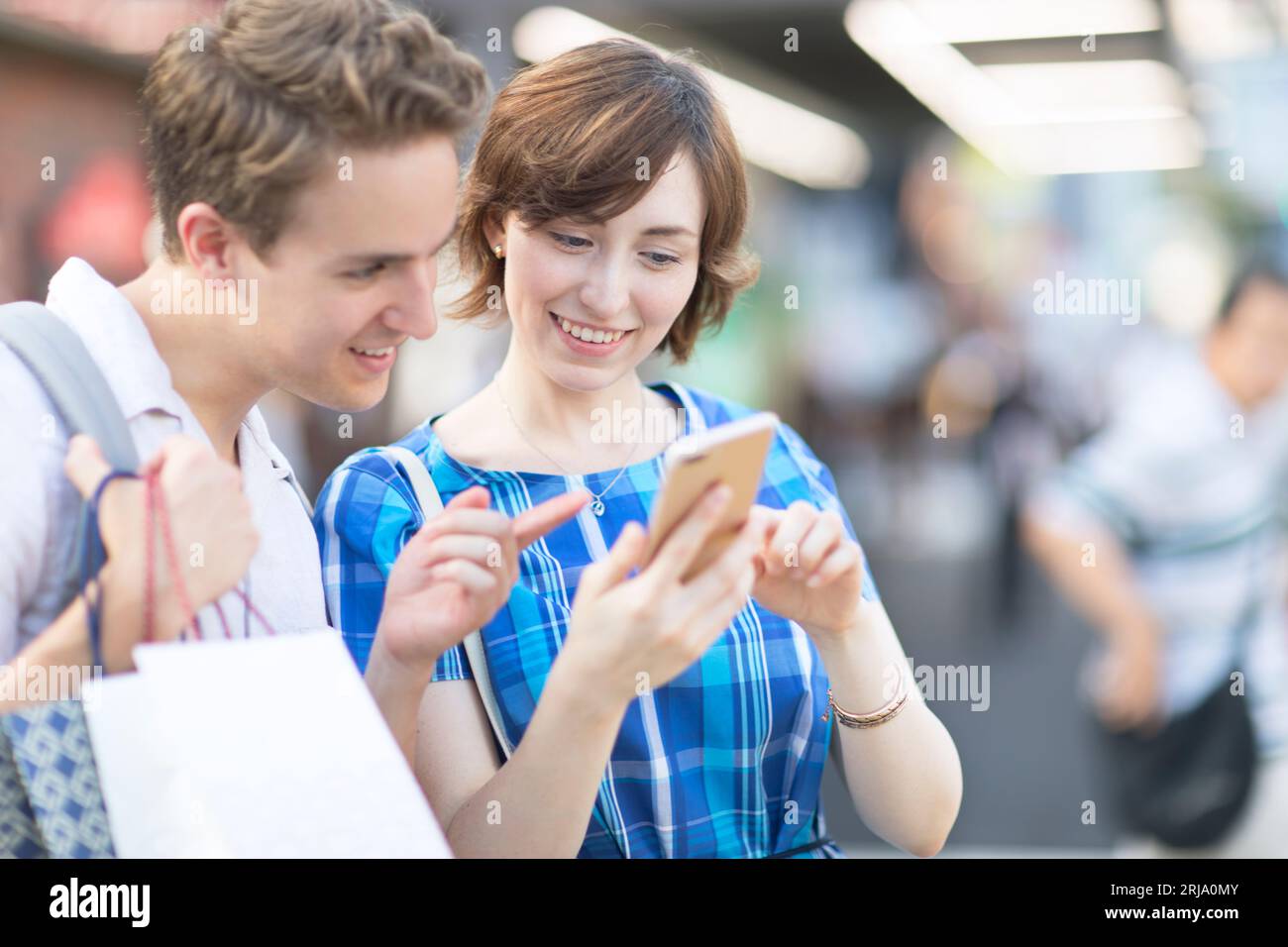 A foreign tourist checking where she is going on her smartphone Stock Photo