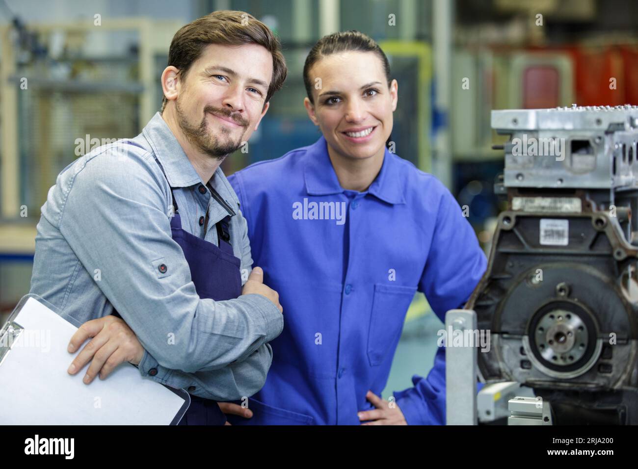 man and woman next to machine Stock Photo