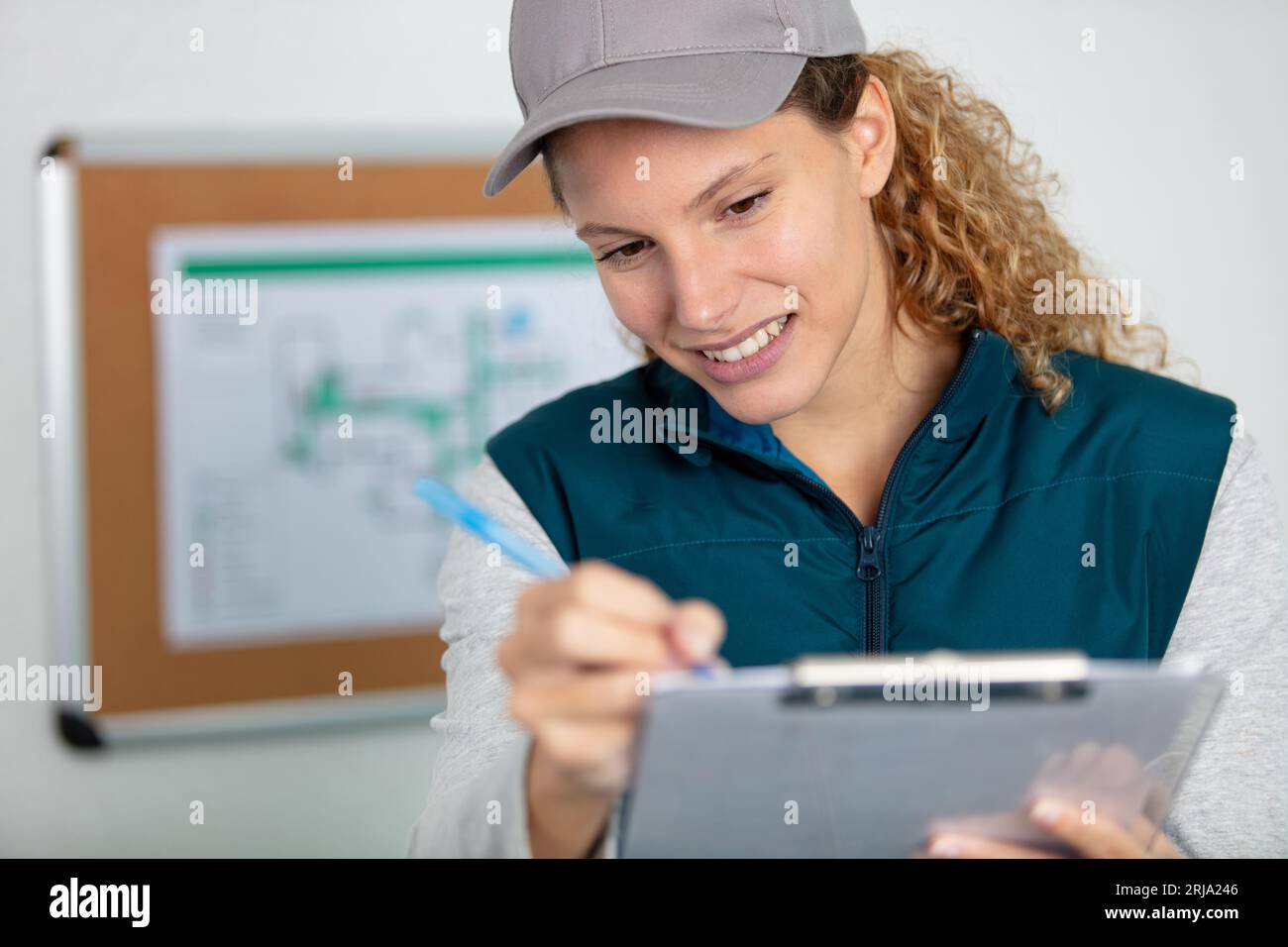 female contractor at a work site using a clipboard Stock Photo