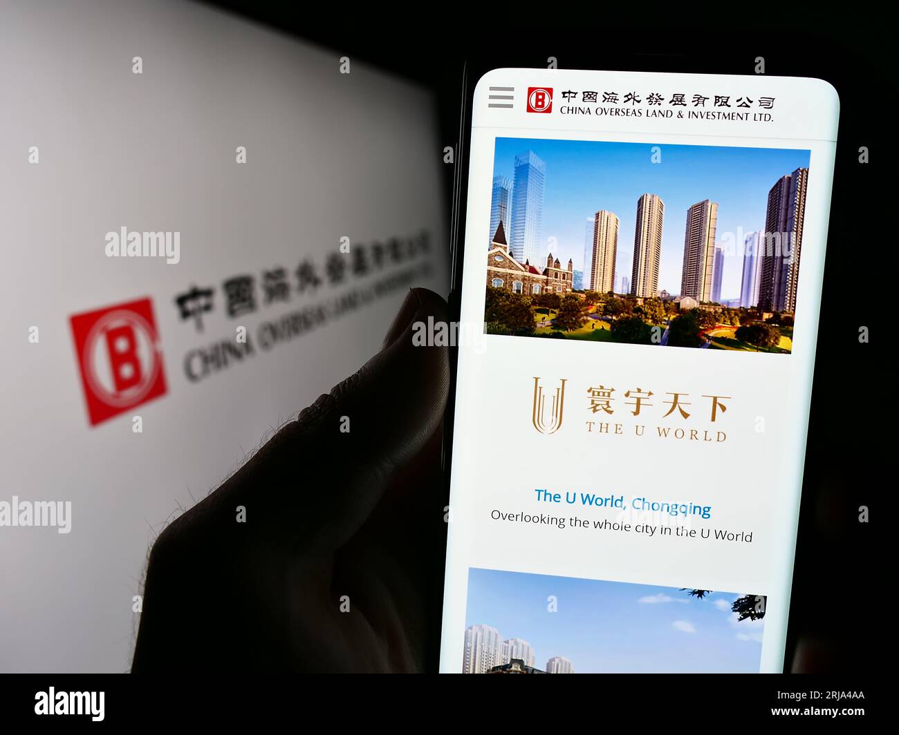 Person holding cellphone with webpage of China Overseas Land and Investment Limited (COLI) on screen with logo. Focus on center of phone display. Stock Photo