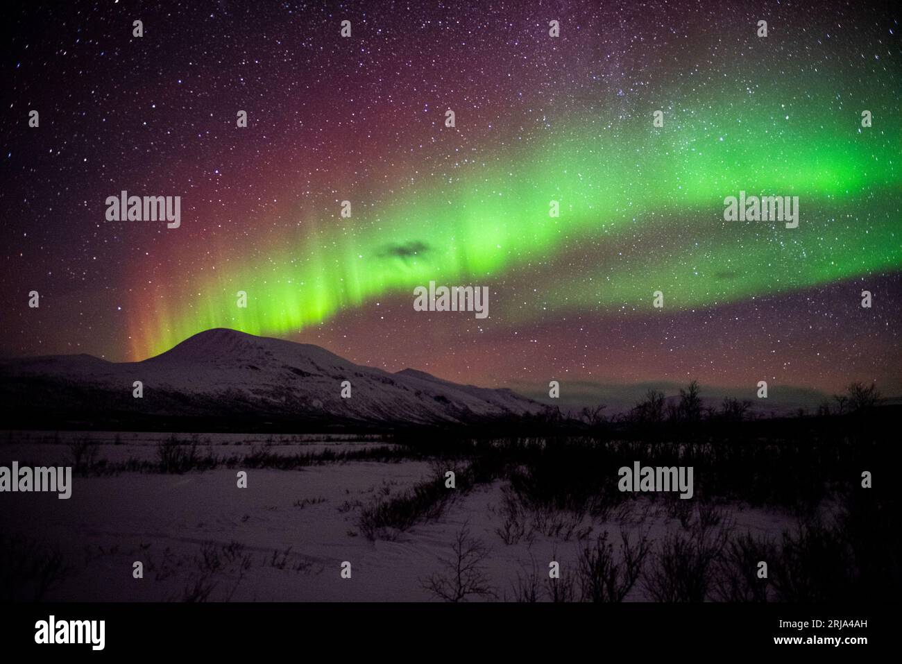 A stunning aurora borealis illuminating the night sky above the rural ...
