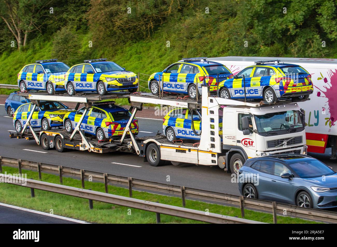 Greater Manchester. UK Business. 22 Aug 2023.  New Skoda Police vehicles being transported on car transporter. Replacement cars for Lancashire Police.  BMW, the original supplier, has stopped supplying police cars to forces across the UK after an inquest heard how a PC was killed in a crash on the M6 following an engine failure in his patrol car. There had been similar incidents involving police cars with the same type of engine in the years prior. Faults had been identified in a diesel engine associated with high mileage and long periods of engine idling. Credit; ZarkePixs/AlamyLiveNews Stock Photo