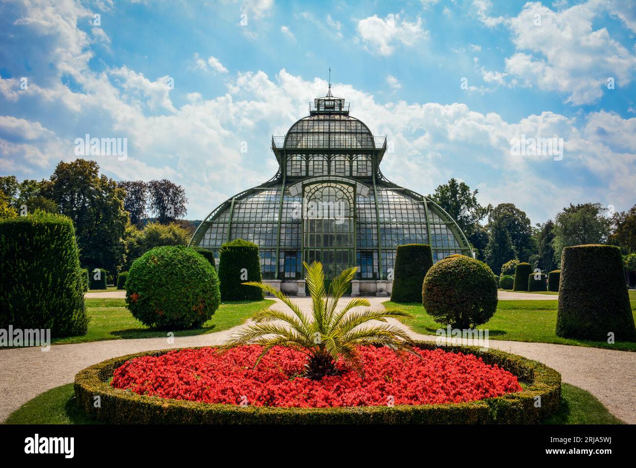 Red Flowers by the Palm House in Schonbrunn Palace Gardens - Vienna, Austria Stock Photo