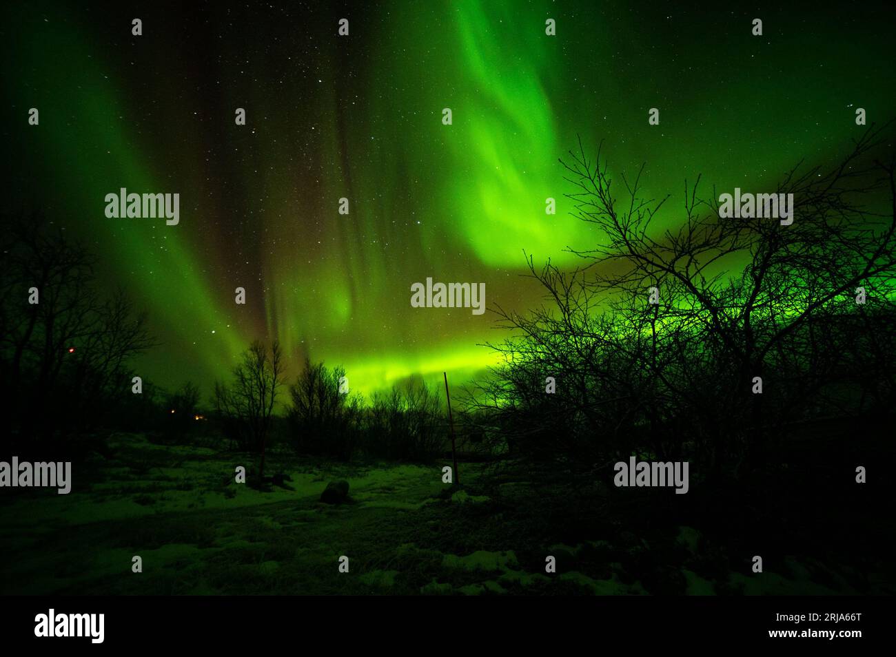 A stunning aurora borealis illuminating the night sky above the rural ...