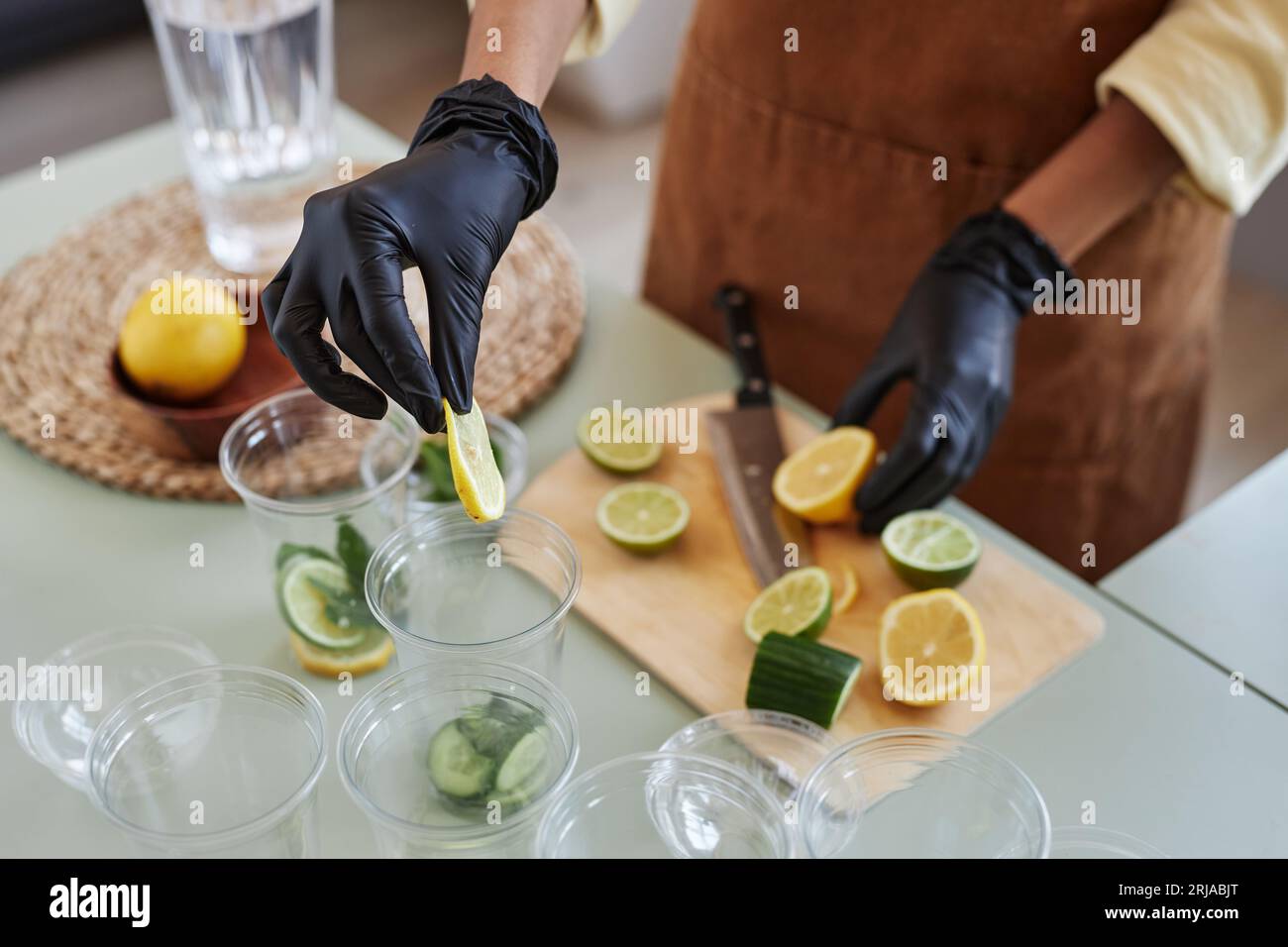 Hand adding lime slice cocktail hi-res stock photography and images - Alamy
