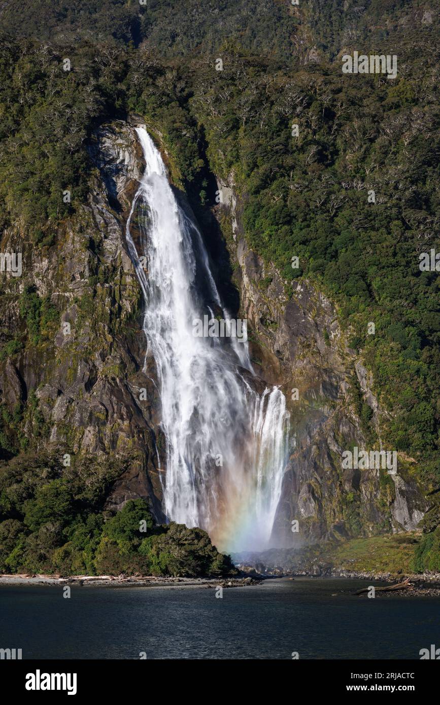 A large waterfall located in the Milford sounds, of New Zealand. There ...