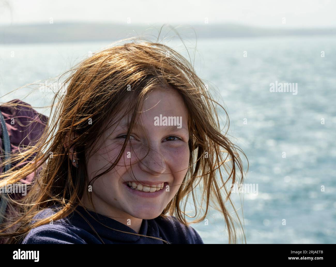 Teenage English girl windswept and smiling on Cross Chanel boat trip ...