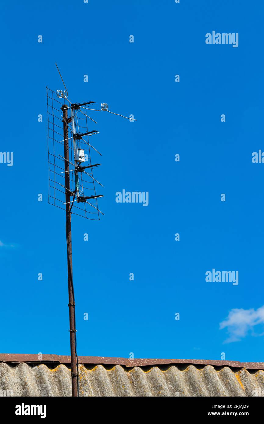 old television antenna against the blue sky. signal receiving antenna
