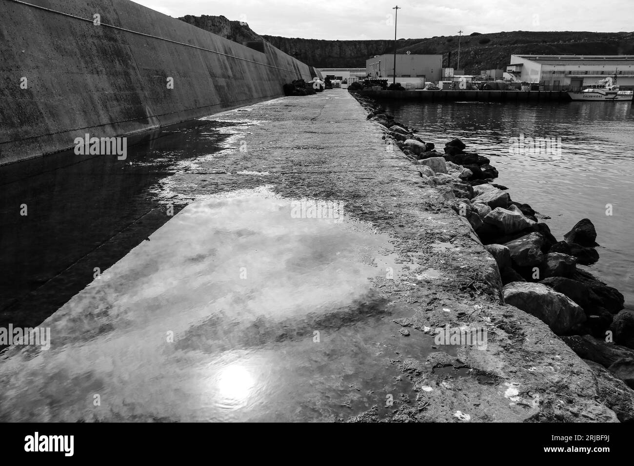 Reflection of the sun on a puddle in the port of Sagres, Portugal Stock