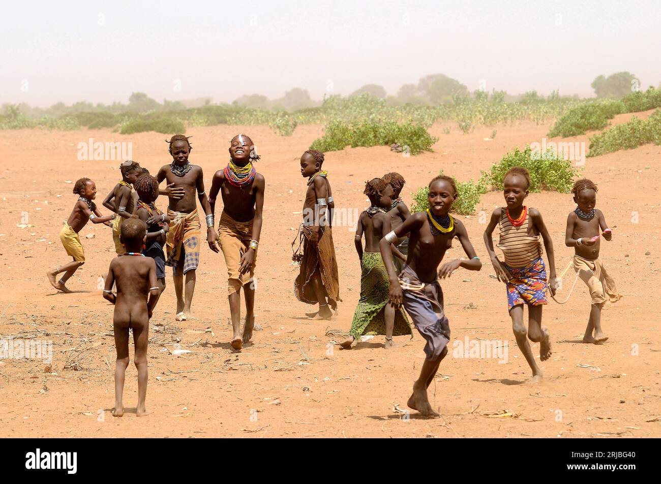 Boys and girls daasanech playing in the middle of a sandstorm. Debub Omo Zone, Ethiopia. Stock Photo