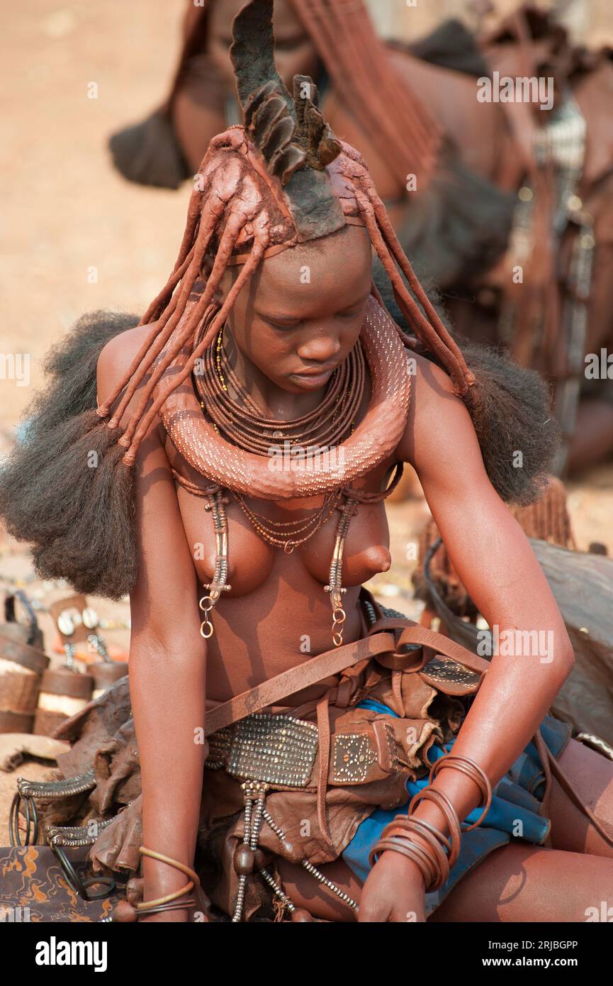 Himba girl in his village. Hairstyle detail. Epupa, Kunene Region, Kaokoland, Namibia. Stock Photo