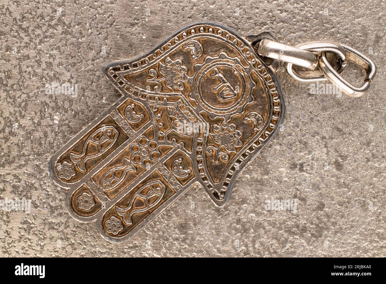 One metal keyring, Jewish 'Hand of Miriam' on metal, close-up, top view. Stock Photo