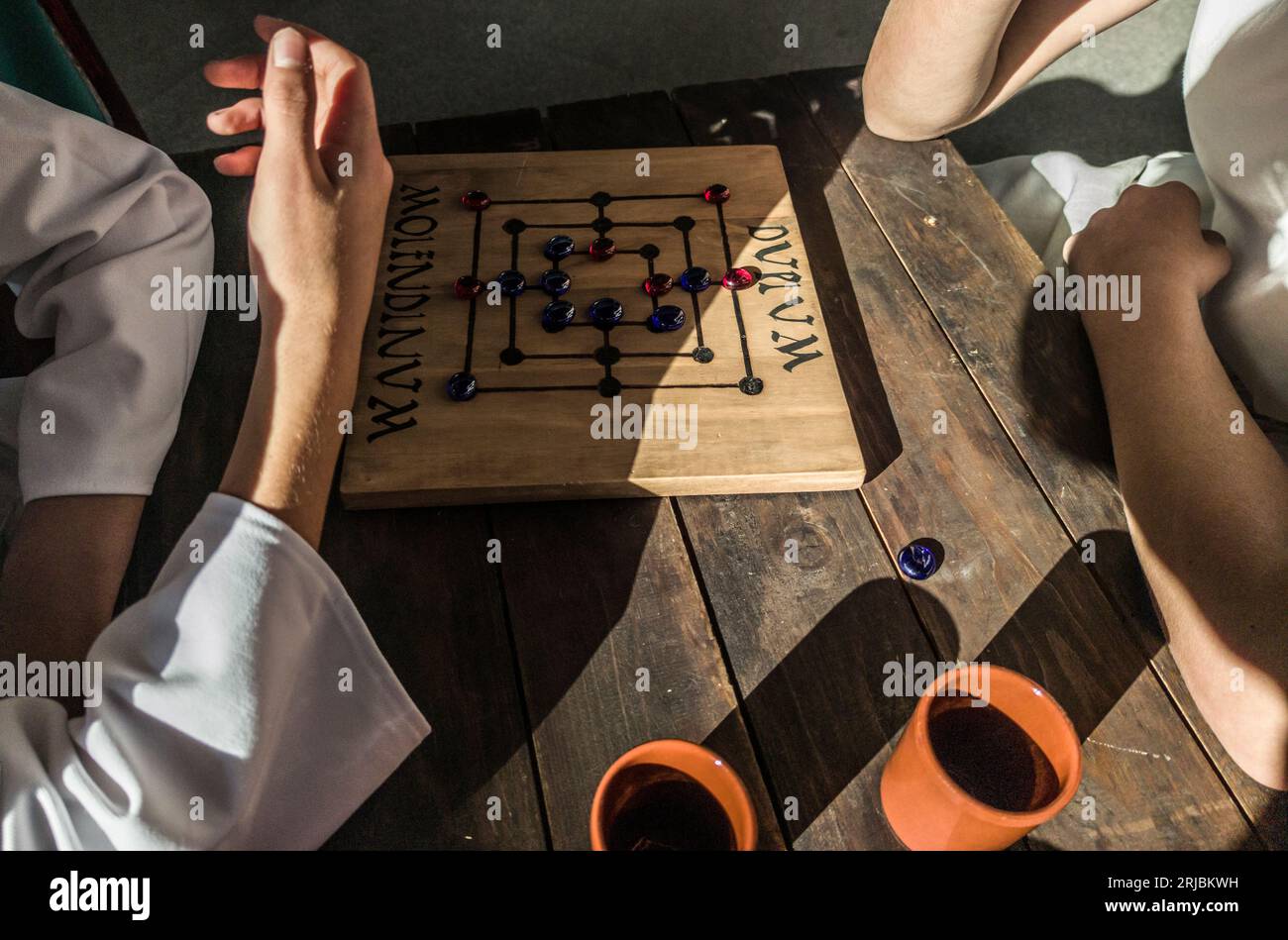 Reenactors playing molendinum, ancient roman board game Stock Photo Alamy