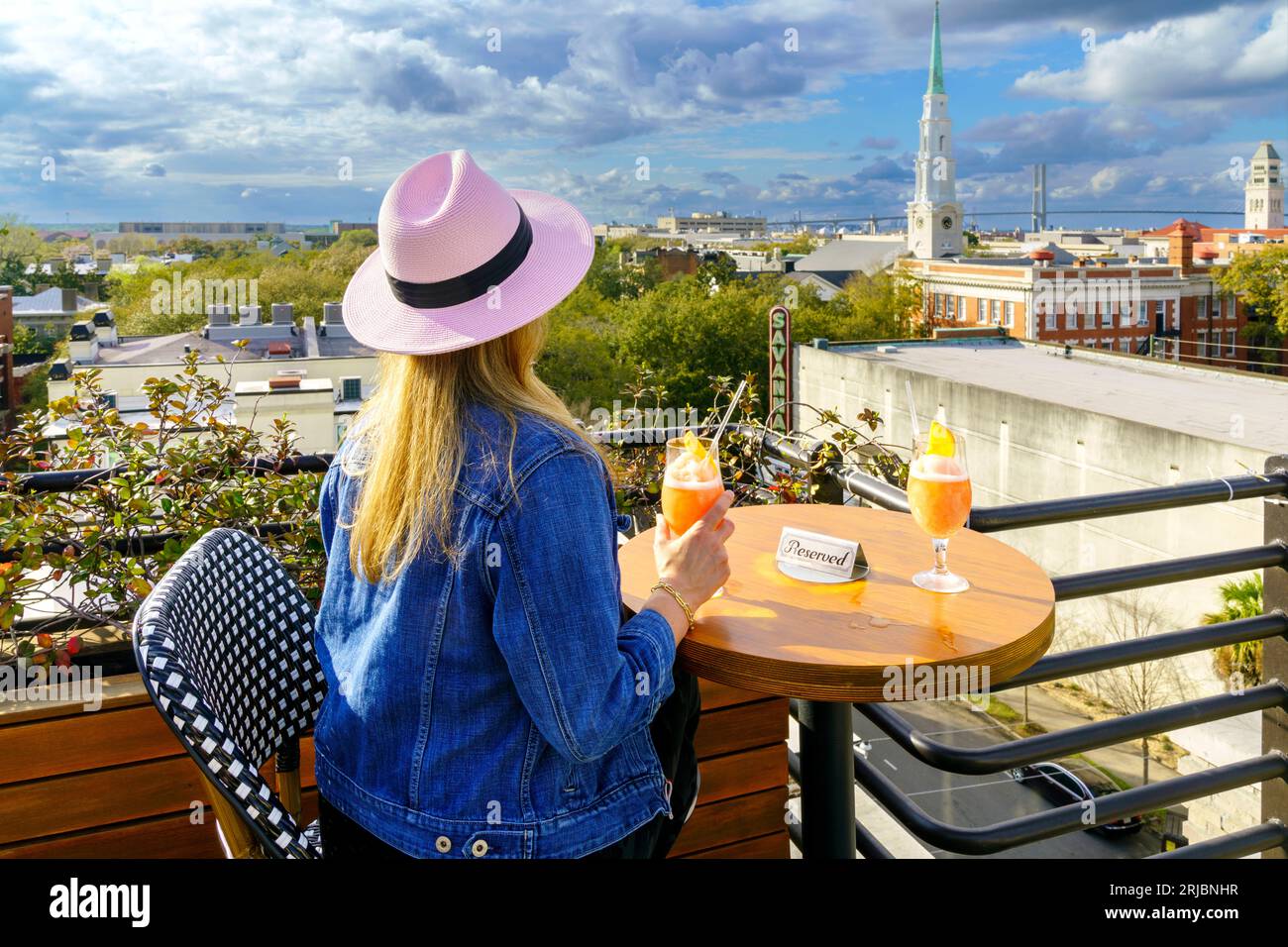Skyline of Savannah,Woman enjoying the View and a Frozee Frozen Cocktail at a Roof Top Bar Savannah,Georgia, United States of America Stock Photo