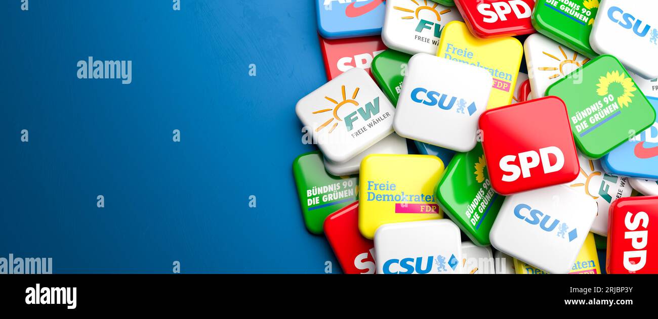 Logos of the main political parties (CSU, Freie Wähler, Die Grünen, SPD, FDP, AfD) running for the Landtag election in Bavaria on a heap on a table. C Stock Photo