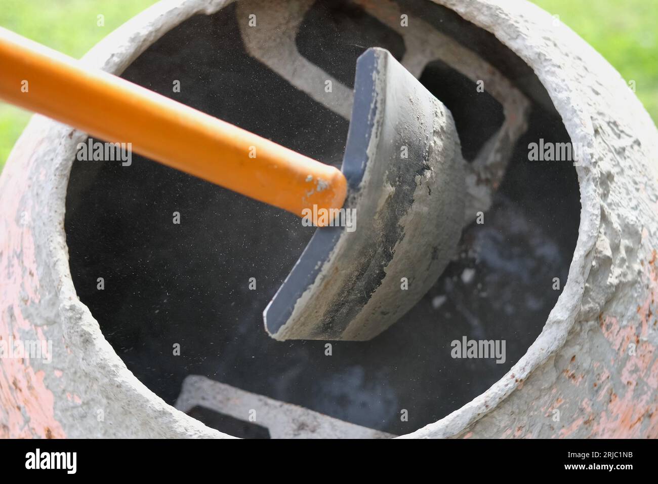 Construction site. Adding lime, sand and stones to rotating cement