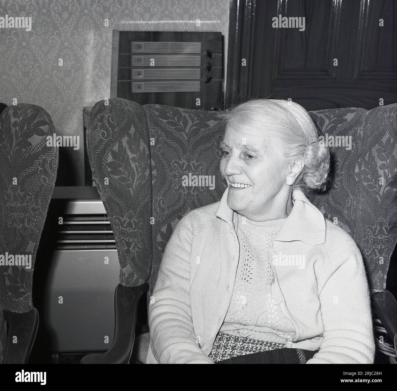 1960, historical, a young looking elderly lady sitting in a lounge