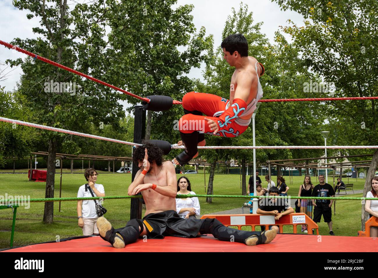The Bilbao wrestler, Jack Lafita did drop kick opponent, Issi in fiestas de Loiu. Stock Photo