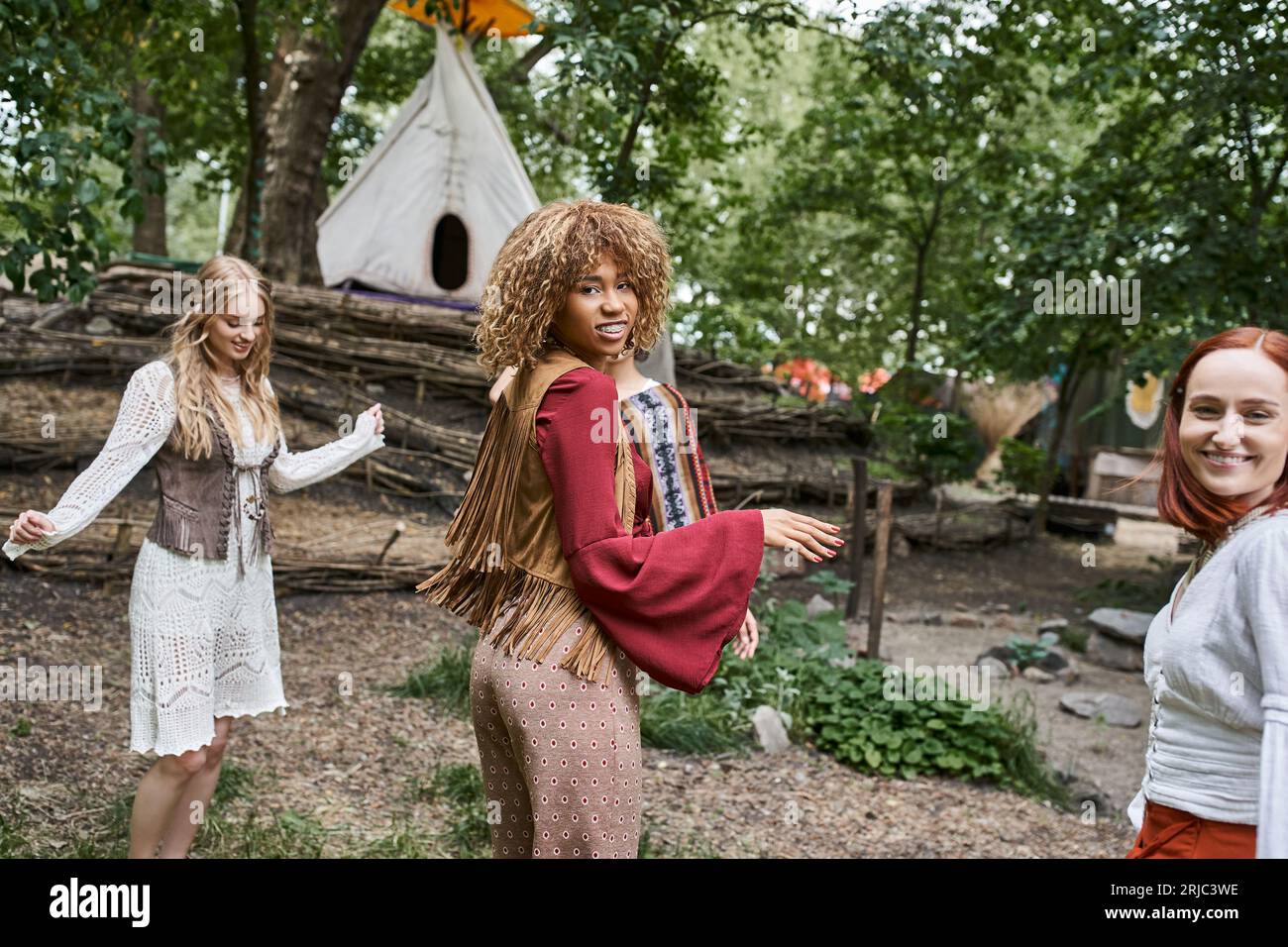 Joyful Interracial Girlfriends In Trendy Outfits Dancing On Lawn In 